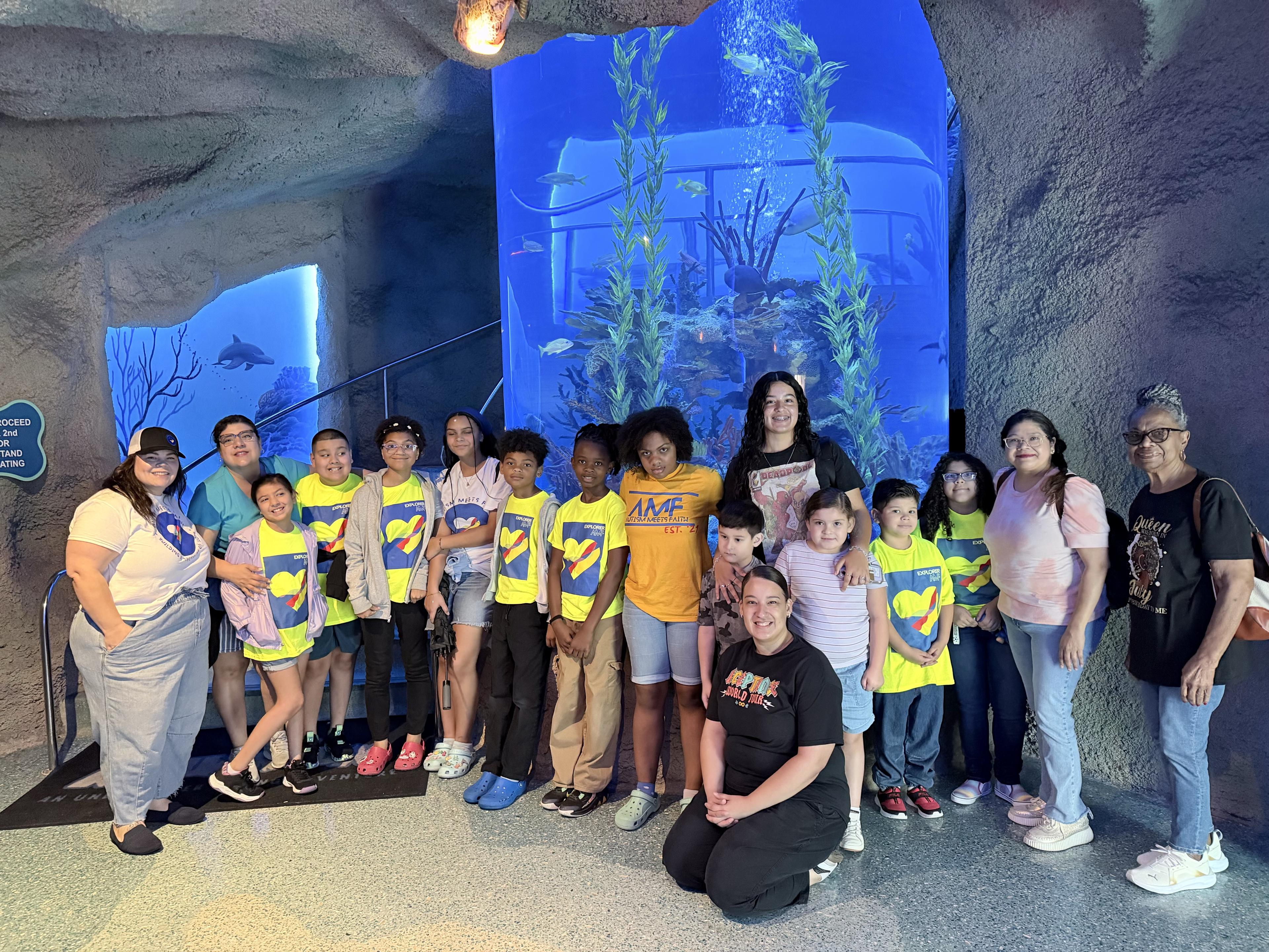 Autism Meets Faith families, children, and team members gathered together at an Explorers Club aquarium experience.