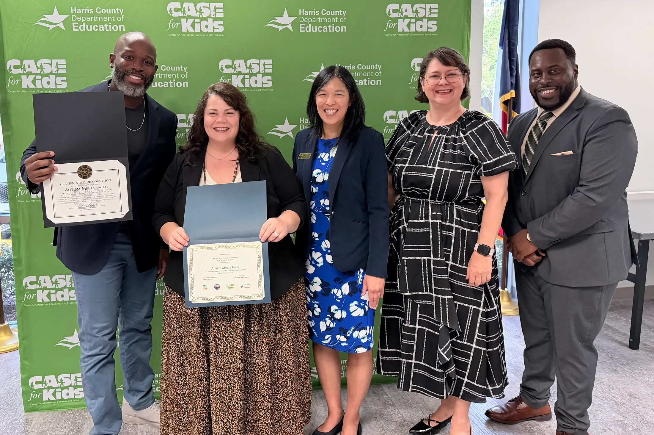 Autism Meets Faith representatives stand together after receiving community recognition.