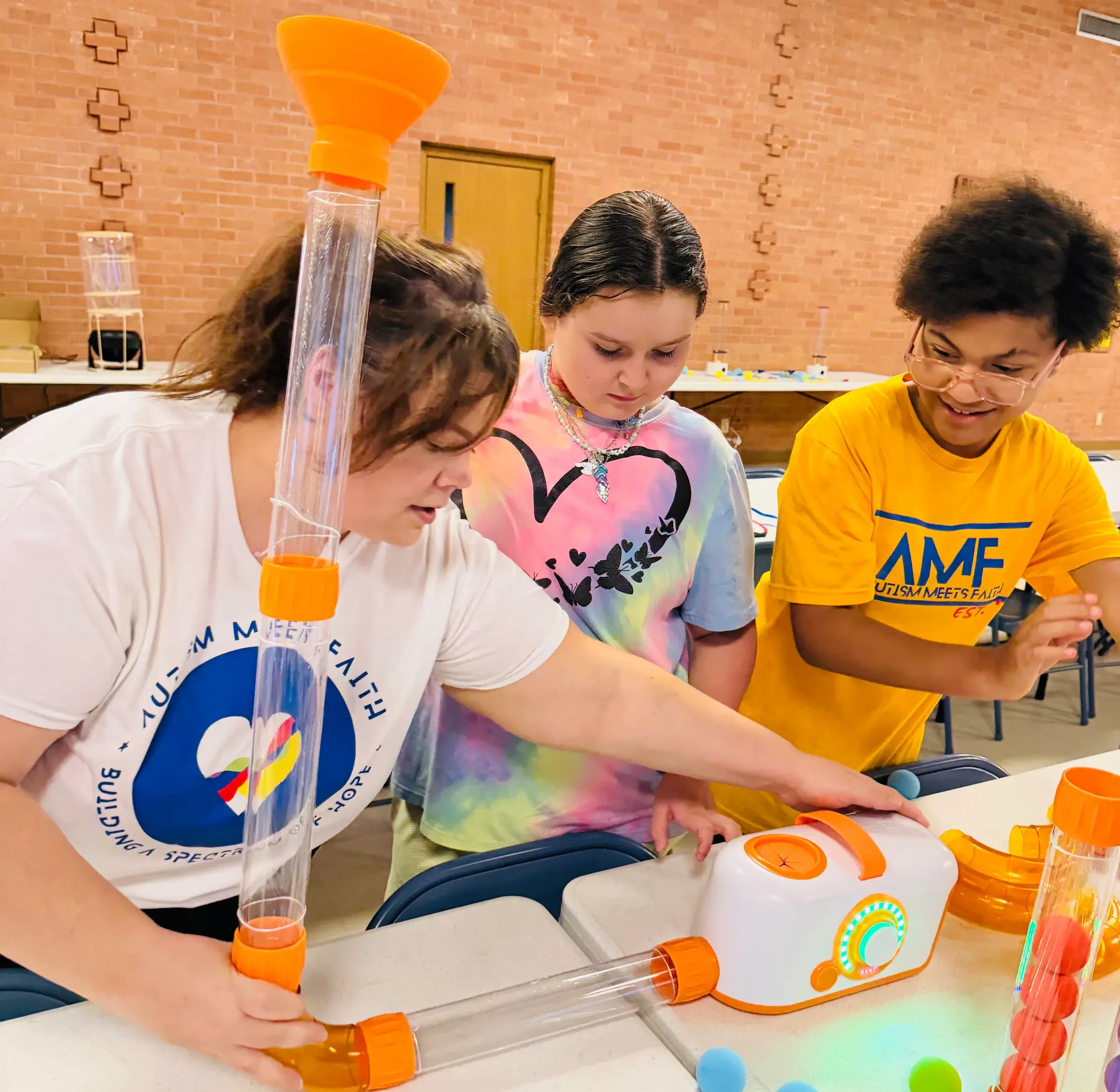 Children explore a hands-on science activity at an AMF program.