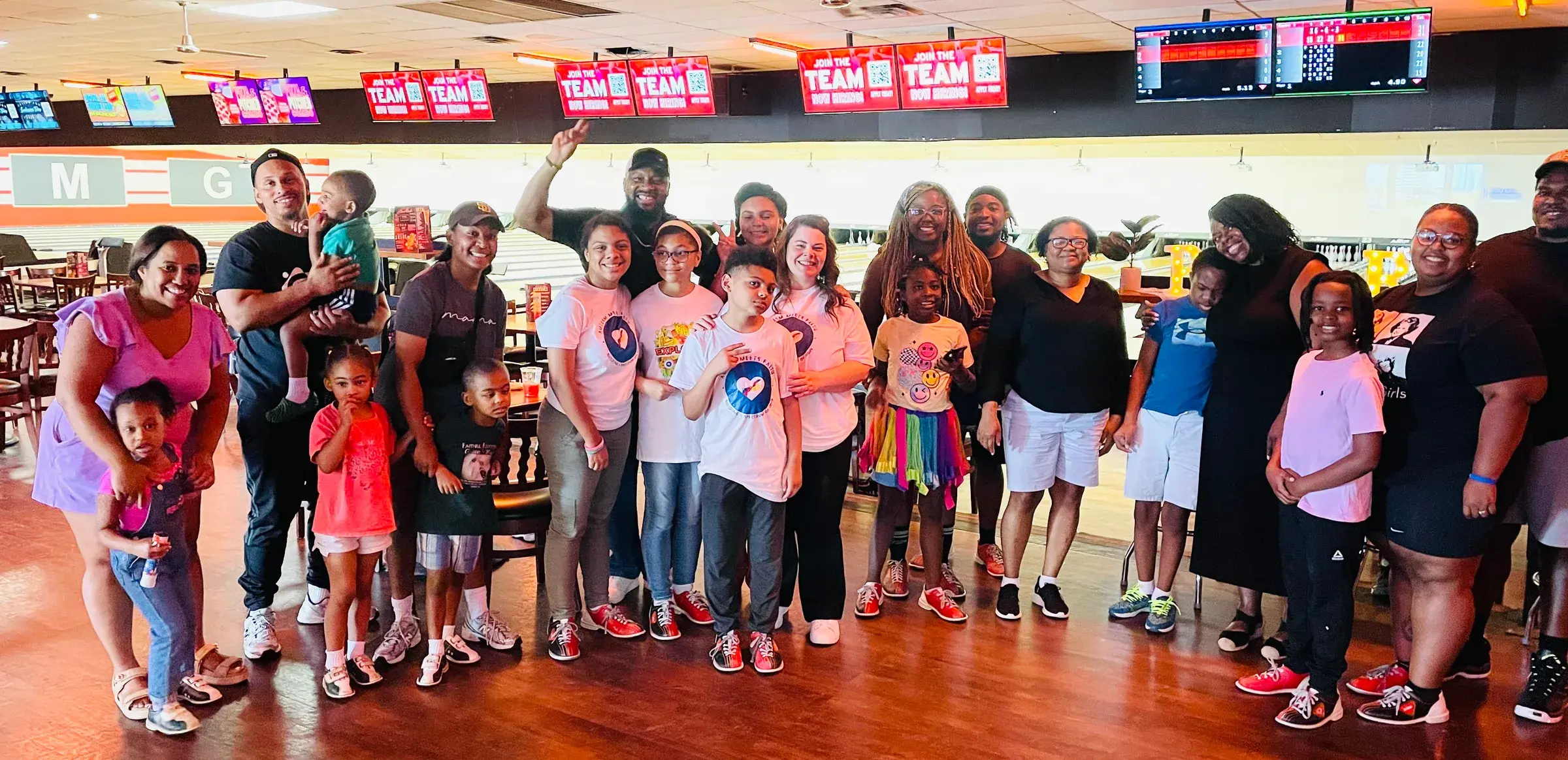 Families and participants pose together during a group activity.