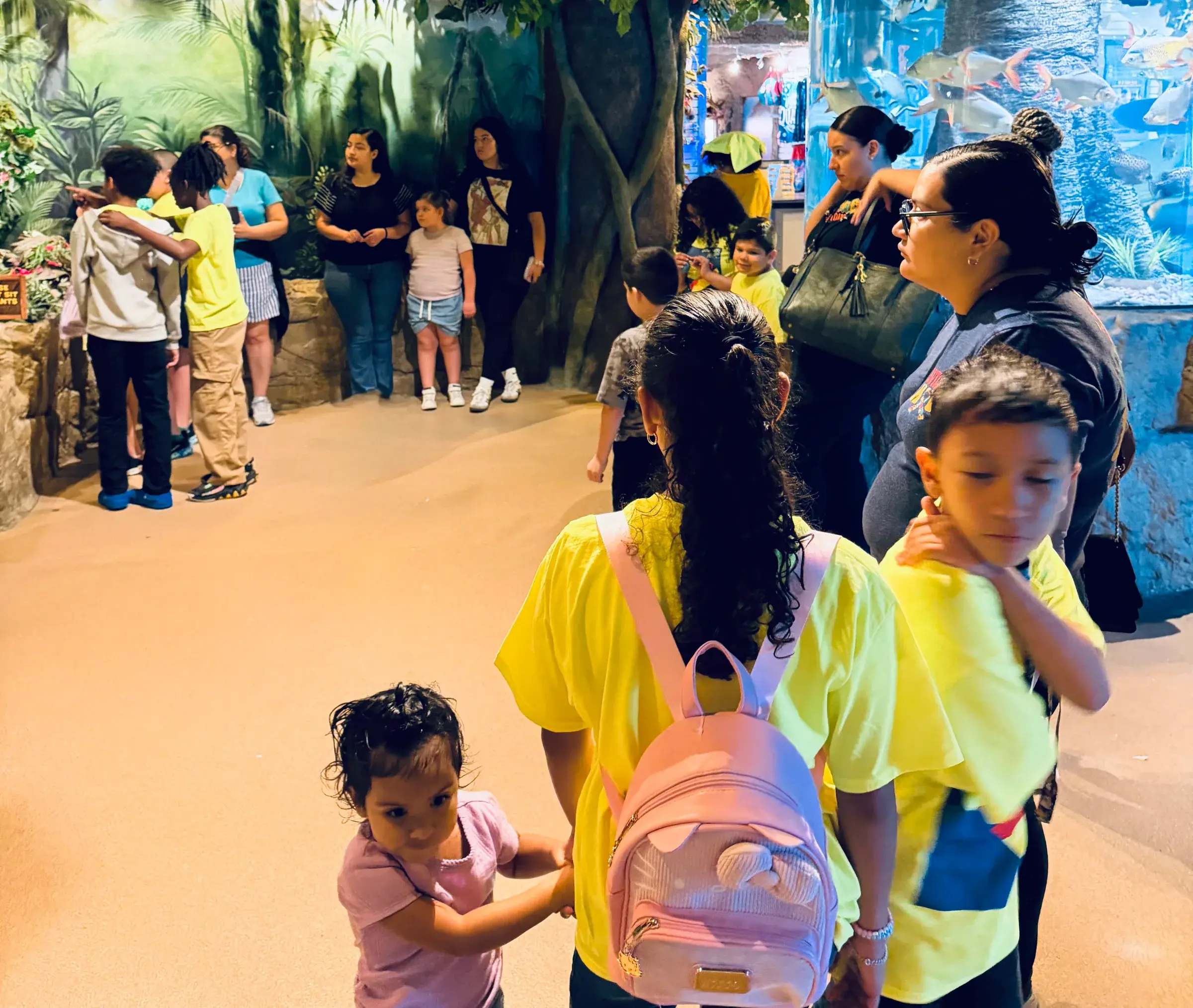 Families visit an aquarium exhibit during an AMF outing.