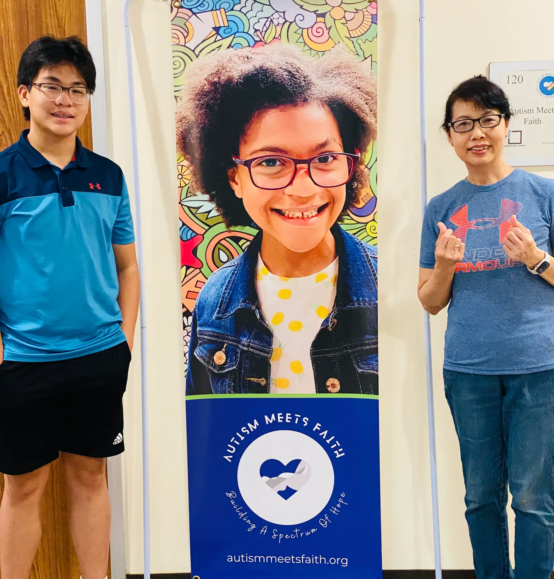 An AMF display features a portrait, with two people standing beside it.