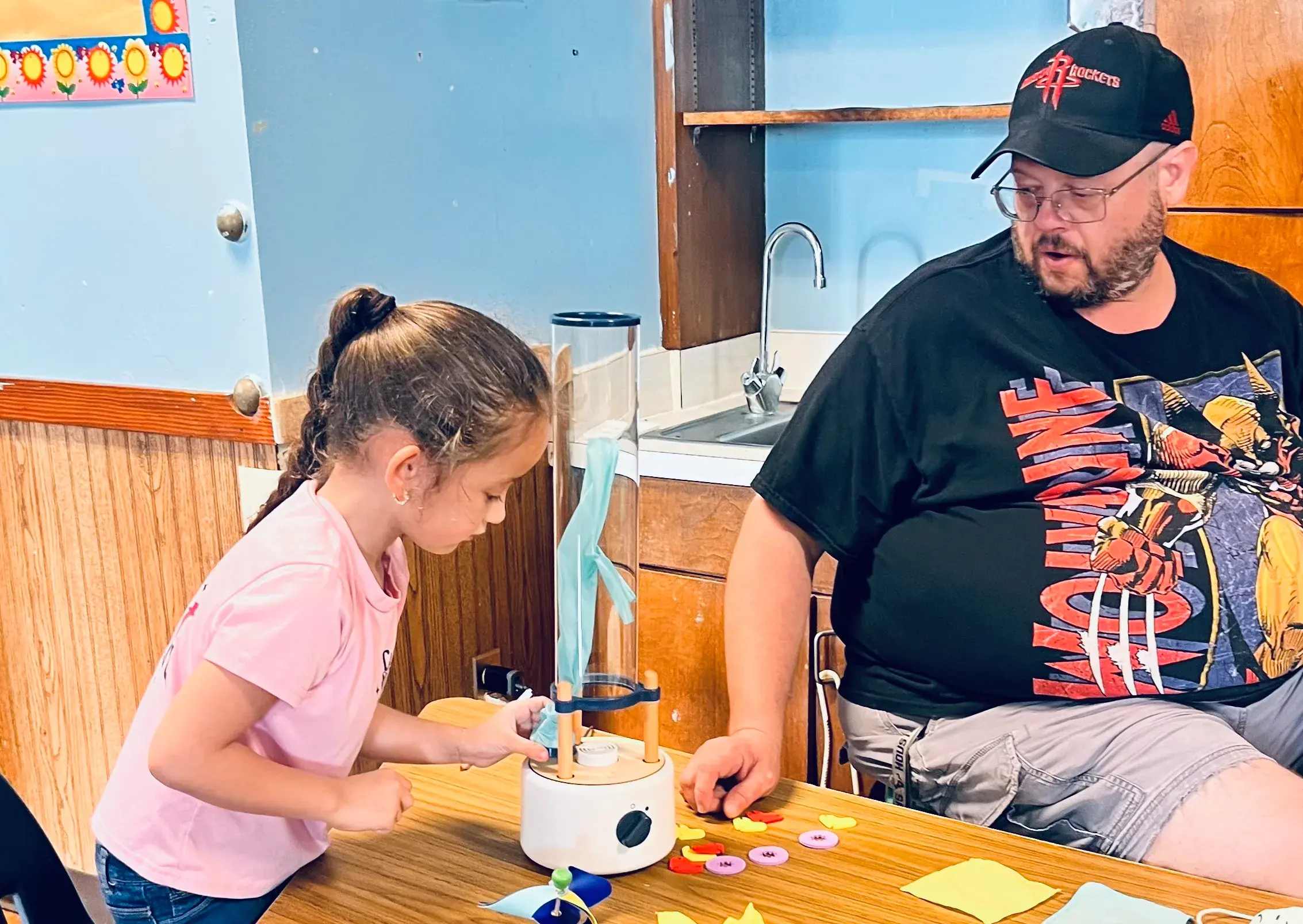 A child and adult work together on a hands-on activity.